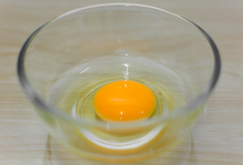 egg in bowl on wood background