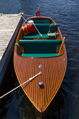 Classic wooden boat at a dock © Les Palenik