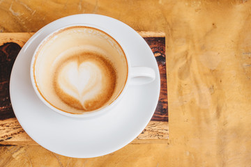 Close up of the latte art in heart shape at the bottom of a cup of hot coffee.