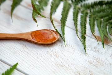 skin care and body scrub with natural ingredients on a spoon Close up. on white wooden background. flat lay