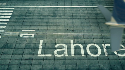 Fototapeta na wymiar Aerial view of an airplane arriving to Lahore airport. Travel to Pakistan 3D rendering
