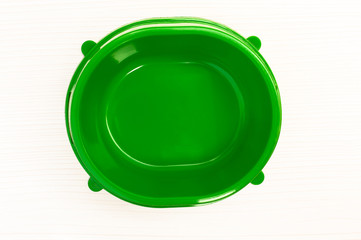 green empty plastic bowl for feeding animals