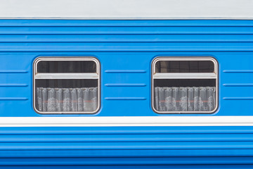 Symmetrical windows of the blue locomotive wagon.