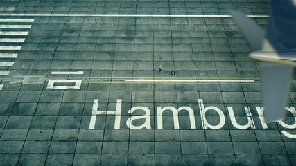 Obraz premium Aerial view of an airplane arriving to Hamburg airport. Travel to Germany 3D rendering