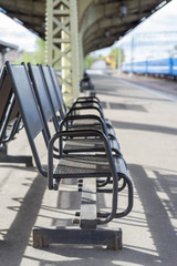 Blurred image of waiting chair zone in railway station.