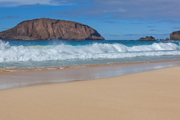 Big waves on the magnificent  beach with golden sand on Graciosa island near Lanzarote, Canary Islands, Spain