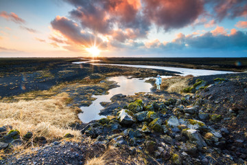 Beautiful black volcanic river landscape of Myrdalssandur in the southern part of Iceland at sunrise in winter. 