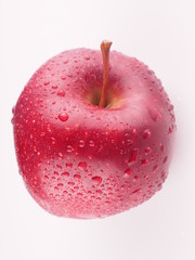 Red apple on a white background with droplets