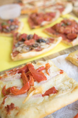 pieces various of homemade pizza on a wooden table