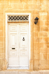 White entrance door to the house in the Island of Malta.