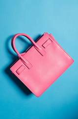A leather designer handbag, floating against a background, shot in a studio with sharp light and...