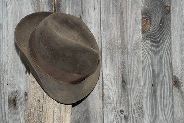 Hat hanging on a wooden wall for background and texture