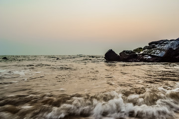 Fototapeta premium Sunset on a Beautiful Beach with Rocks, Goa, India