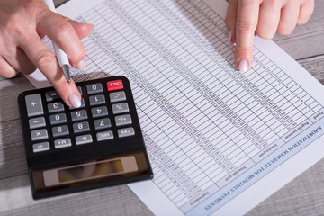 Hands of an accountant working on financial documents