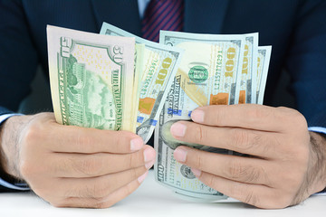 Businessman counting money,US dollar (USD) bills