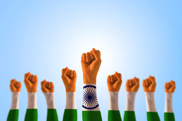 India national flag pattern on leader's fist isolated on blue sky (clipping path) for Human equal...
