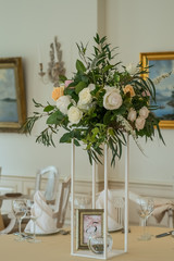 Decorated wedding table with flowers, dining set and a candle