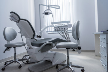 Fototapeta na wymiar empty dentist office with chair and various dental equipment
