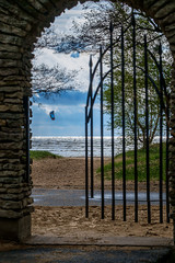 Gates to the beach with a kite surfer on the background
