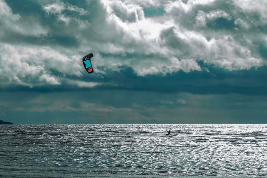 Kite boarding. Kite surfer freestyle at sunset.