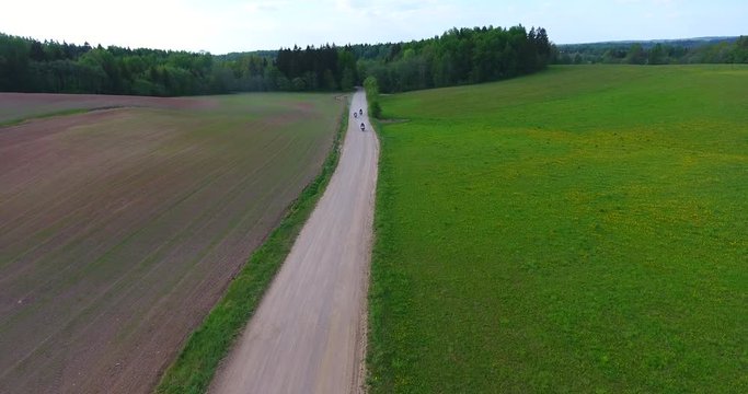Motorcyclists touring Lithuania passes by on an enduro road bike, suited for gravel road and with pack and panniers full of supplies for traveling and camping.