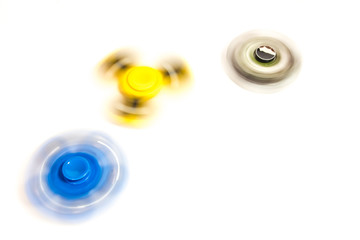 fidget hand spinner spinning on white background