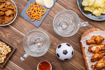 Appetizers and beer on the table for watch the football match.