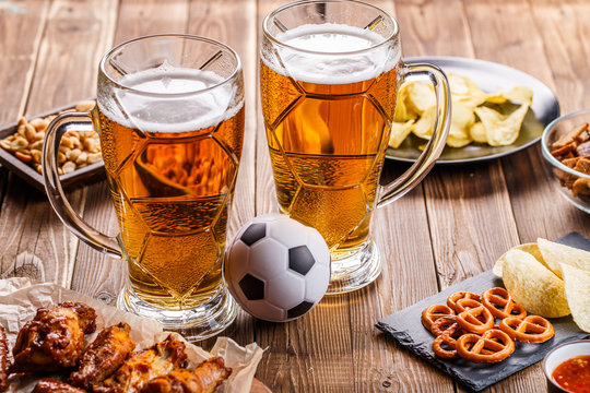 Appetizers and beer on the table for watch the football match.