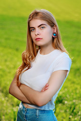 Portrait of a young beautiful woman with wooden tunnels in her ears