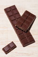 A lot of variety chocolates bar in box on white wooden background