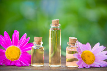 Essence of flowers on table in beautiful glass jar