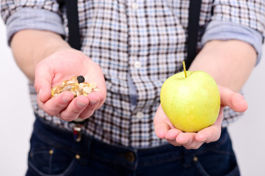 Idea of proper nutrition and treatment. Mans hands hold apple