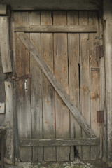 Old wooden door with rusty loops