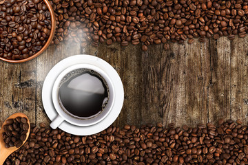 Coffee cup and beans on old wood table. Top view with copy-space for your text