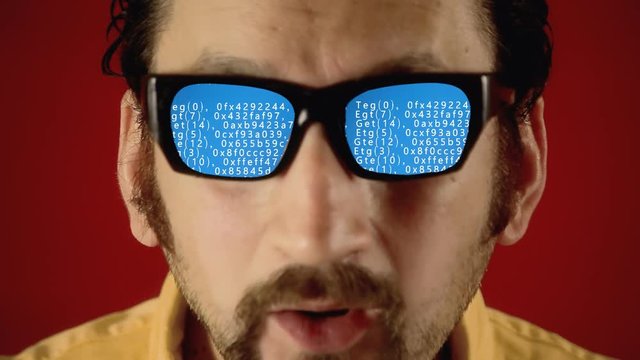 A funny ugly man with hypnotic glasses, looking at blue grad source code scrolling down (scrambled text from public domain).
