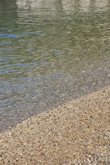Beach with soft waves and small stones, Blue sea in summer, Beach backgrounds