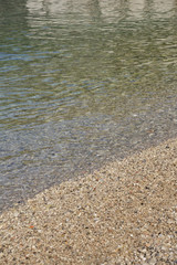 Beach with soft waves and small stones, Blue sea in summer, Beach backgrounds