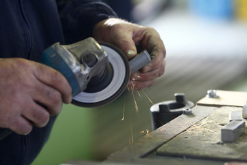 Shaping a metal with a grinder