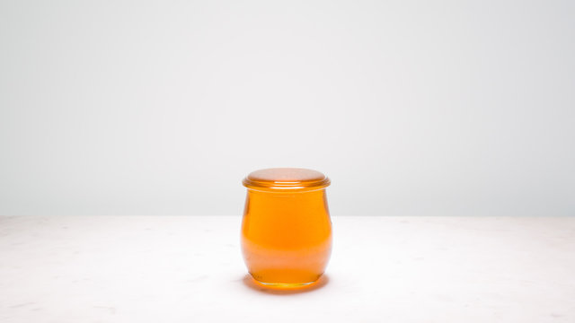 Perfectly full jar of honey with copy space on both sides. Life is full and sweet!