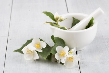 Obraz na płótnie Canvas Spa concept - making essential oil with jasmine flowers