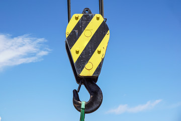 Fototapeta premium Big yellow construction crane on blue sky background
