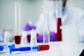Close up of a  syringe with blood. Analyzing blood in the laboratory.