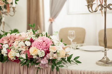 Beautiful decoration on wedding table with roses in bouquet