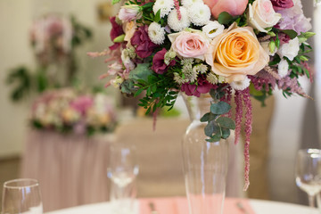 Beautiful decoration on wedding table with roses in bouquet