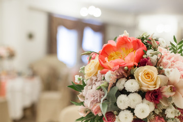 Beautiful decoration on wedding table with roses in bouquet