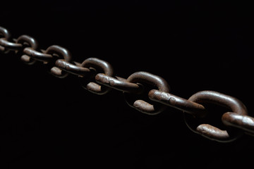 Obraz premium Steel chain spotlighted punctual diary lights on black background.