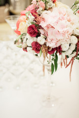 Beautiful decoration on wedding table with roses in bouquet