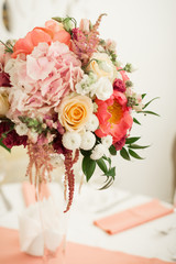 Beautiful decoration on wedding table with roses in bouquet