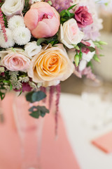 Beautiful decoration on wedding table with roses in bouquet