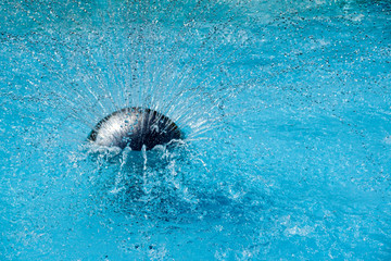 Fountain . Water splashing into swimming pool
